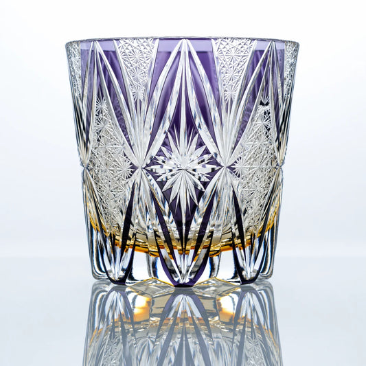 An amethyst hand-cut Edo Kiriko whiskey glass featuring elongated fan-cut crystal details, fine geometric textures, a central starburst motif, and a polished reflective studio presentation.