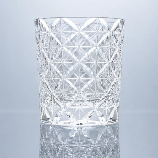 A clear hand-cut Edo Kiriko crystal whiskey glass featuring a traditional Shippo-inspired lattice pattern, transparent faceted detailing, and a polished reflective studio presentation.