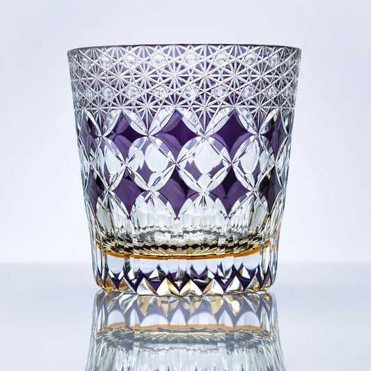 An amethyst hand-cut Edo Kiriko whiskey glass featuring fine lattice starburst cuts, a rich violet mosaic-style band, clear faceted crystal detailing, and a polished reflective studio presentation.
