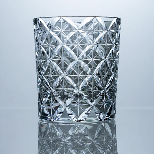 A smoke gray hand-cut Edo Kiriko whiskey glass featuring an allover Shippo-inspired crystal lattice pattern, clear-gray tones, and a polished reflective studio presentation.