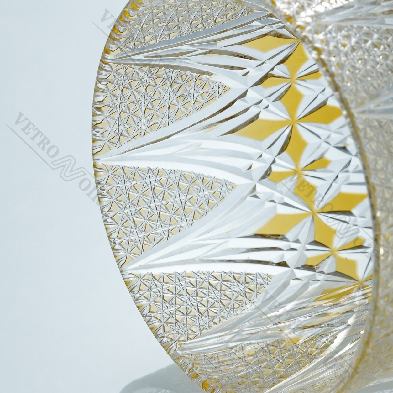 Angled close-up of Imperial Sunburst Edo Kiriko whiskey glass showing detailed geometric cuts and golden accent patterns.