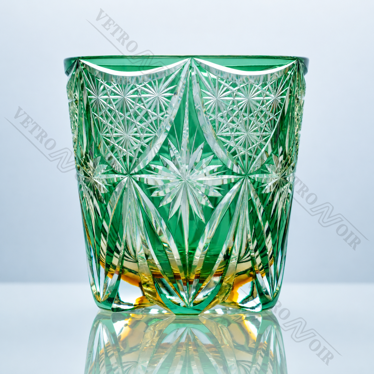 Emerald Gilded Starburst crystal whiskey glass with green crystal body, golden accents, and hand-cut starburst pattern.