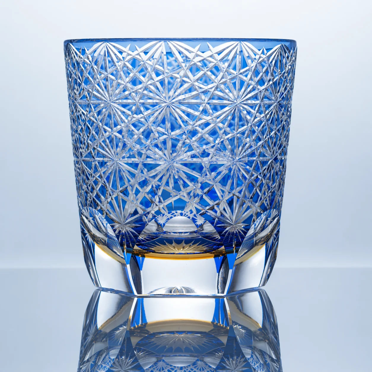 Large blue Edo Kiriko whiskey glass with hand-cut daisy crystal patterns and a clear faceted base.