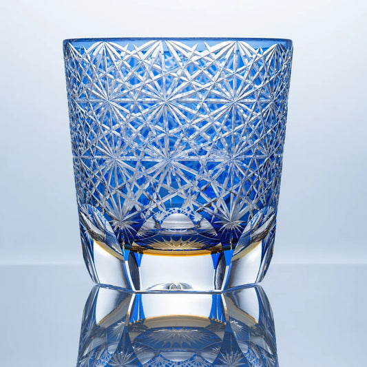 Large blue Edo Kiriko whiskey glass with hand-cut daisy crystal patterns and a clear faceted base.